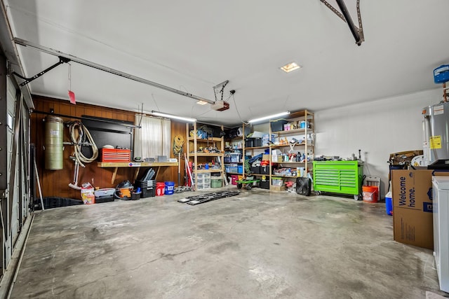 1002 Sunset Ave, Murfreesboro, TN 37129 - garage featuring water heater, a garage door opener, and a workshop area