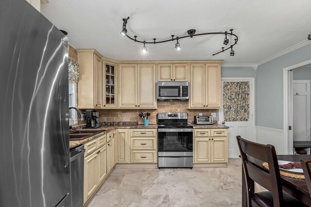 1002 Sunset Ave, Murfreesboro, TN 37129 - kitchen with stainless steel appliances, cream cabinetry, dark stone countertops, wainscoting, and crown molding
