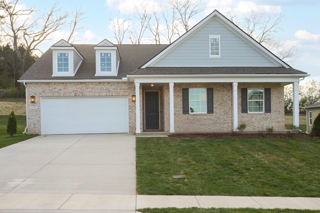 2359 Williamsport Lndg, Columbia, TN 38401 - view of front of house with brick siding, a front yard, covered porch, concrete driveway, and roof with shingles
