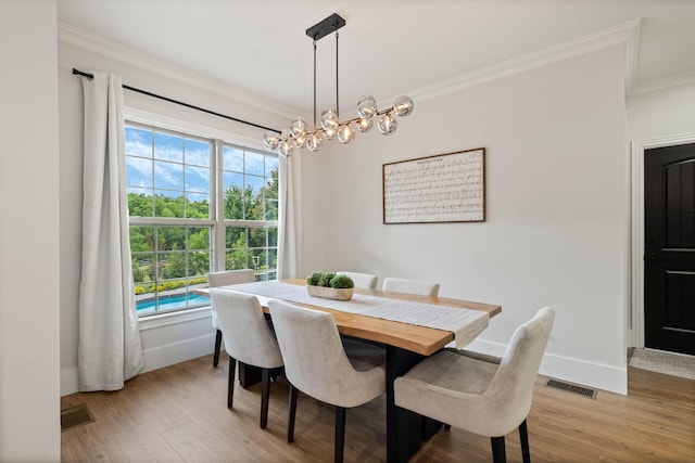 4024 Campania Strada, Spring Hill, TN 37174 - dining room with crown molding, light wood-style floors, and a chandelier