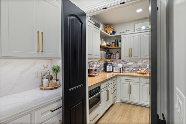 4024 Campania Strada, Spring Hill, TN 37174 - kitchen with backsplash, open shelves, oven, and white cabinetry