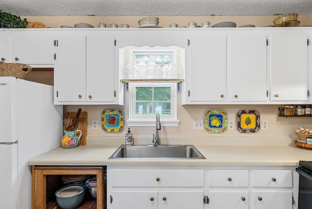 178 Miranda Rd, Cadiz, KY 42211 - kitchen with freestanding refrigerator, light countertops, and white cabinetry
