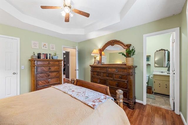 178 Miranda Rd, Cadiz, KY 42211 - bedroom featuring wood finished floors, a raised ceiling, connected bathroom, and ceiling fan
