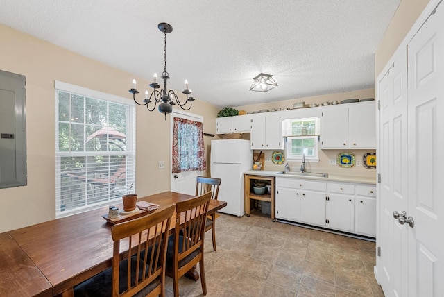 178 Miranda Rd, Cadiz, KY 42211 - kitchen featuring freestanding refrigerator, electric panel, a chandelier, light countertops, and white cabinetry