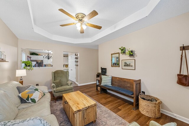 178 Miranda Rd, Cadiz, KY 42211 - living area with a tray ceiling, ceiling fan, wood finished floors, a chandelier, and a textured ceiling