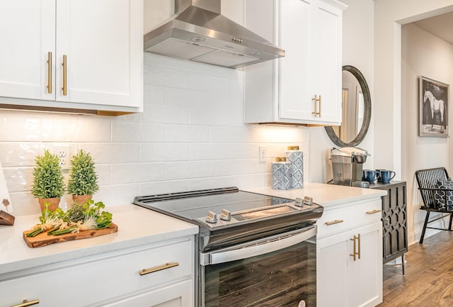 1234 Wrights Mill Rd, Spring Hill, TN 37174 - kitchen featuring wall chimney range hood, stainless steel range with electric stovetop, light countertops, and white cabinets