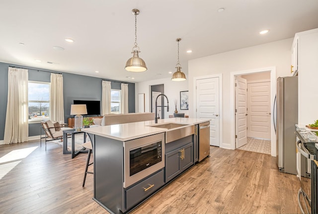 1234 Wrights Mill Rd, Spring Hill, TN 37174 - kitchen with appliances with stainless steel finishes, plenty of natural light, light countertops, a kitchen bar, and recessed lighting
