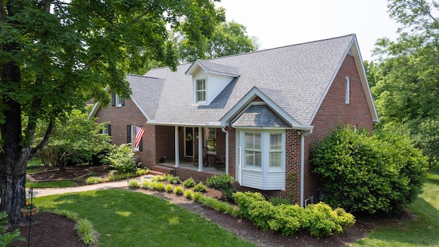 1719 Waterford Rd, Murfreesboro, TN 37129 - new england style home featuring covered porch, brick siding, a front lawn, and roof with shingles