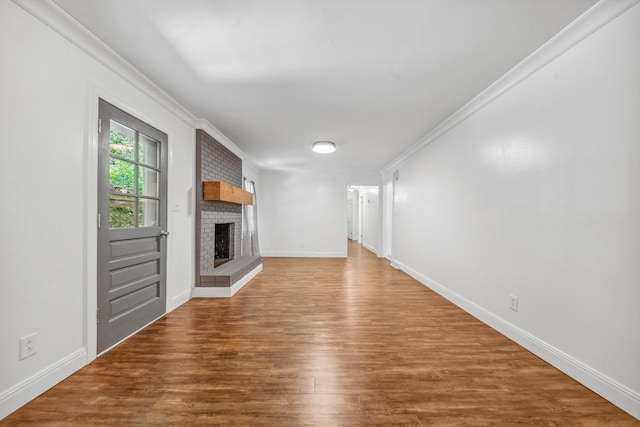 116 Skyview Dr, Columbia, TN 38401 - unfurnished living room with a brick fireplace, wood finished floors, and crown molding