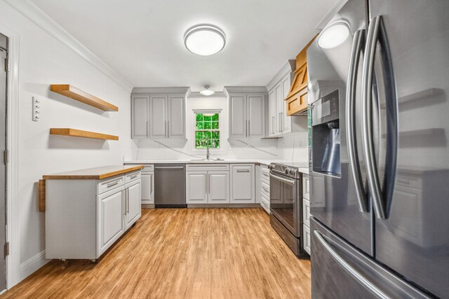 116 Skyview Dr, Columbia, TN 38401 - kitchen featuring stainless steel appliances, light wood-style flooring, open shelves, wood counters, and crown molding