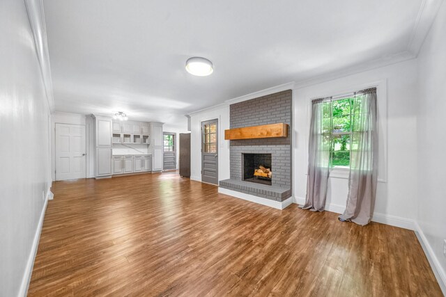 116 Skyview Dr, Columbia, TN 38401 - unfurnished living room with ornamental molding, a brick fireplace, and wood finished floors