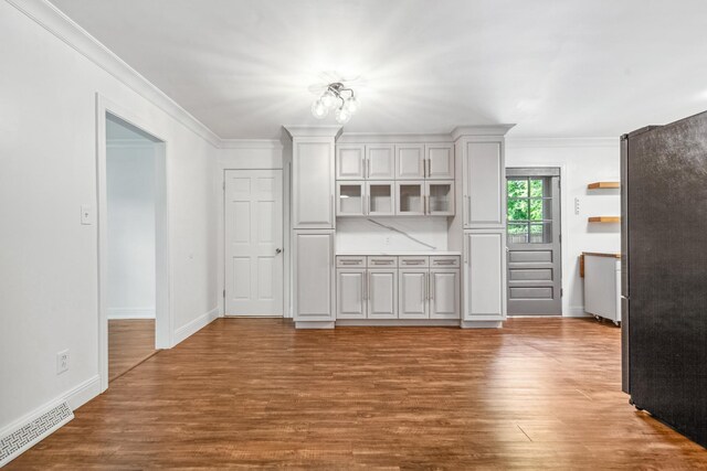 116 Skyview Dr, Columbia, TN 38401 - kitchen with ornamental molding, wood finished floors, glass insert cabinets, and light countertops