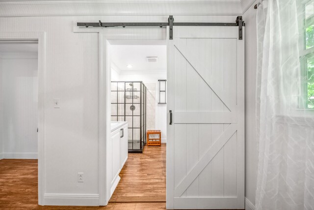116 Skyview Dr, Columbia, TN 38401 - corridor featuring a barn door, light wood-type flooring, and crown molding