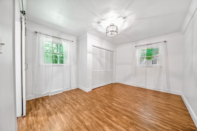 116 Skyview Dr, Columbia, TN 38401 - unfurnished bedroom featuring multiple windows, wood finished floors, a chandelier, and ornamental molding