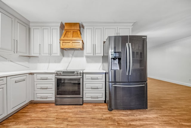 116 Skyview Dr, Columbia, TN 38401 - kitchen with stainless steel appliances, custom exhaust hood, light wood-style flooring, light countertops, and white cabinetry