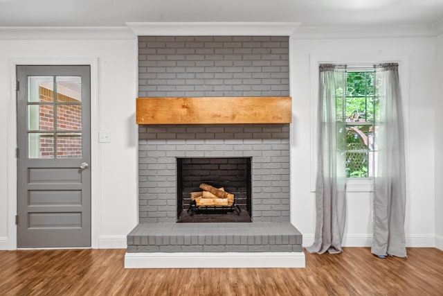116 Skyview Dr, Columbia, TN 38401 - unfurnished living room featuring wood finished floors, a fireplace, and crown molding