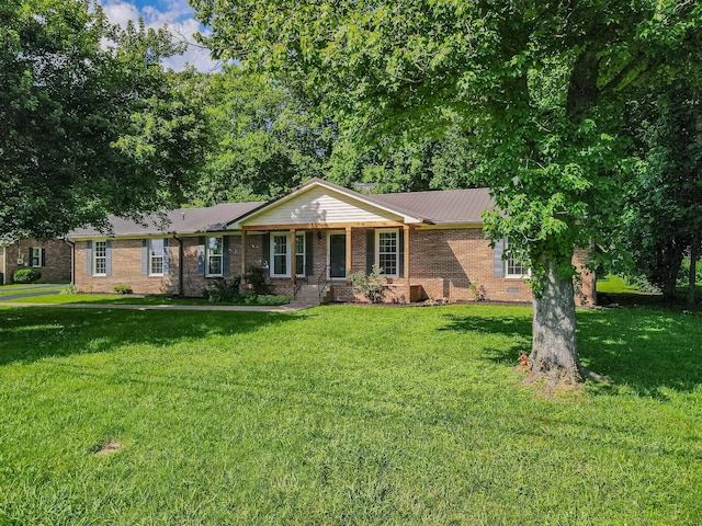 116 Skyview Dr, Columbia, TN 38401 - ranch-style house with a front yard, brick siding, and a metal roof