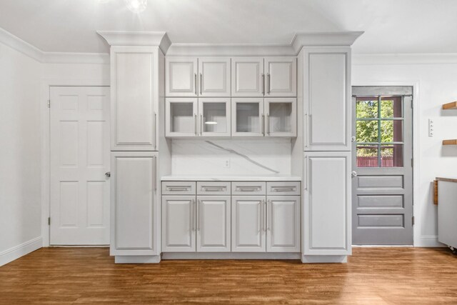 116 Skyview Dr, Columbia, TN 38401 - kitchen with ornamental molding, glass insert cabinets, wood finished floors, light countertops, and white cabinetry