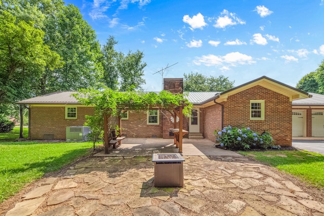 116 Skyview Dr, Columbia, TN 38401 - ranch-style home with brick siding, a metal roof, a front lawn, a patio, and entry steps