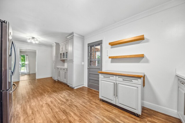 116 Skyview Dr, Columbia, TN 38401 - kitchen featuring crown molding, freestanding refrigerator, light wood-style floors, open shelves, and wood counters