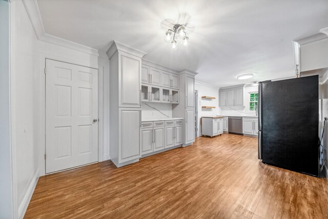 116 Skyview Dr, Columbia, TN 38401 - kitchen with appliances with stainless steel finishes, light wood-type flooring, light countertops, ornamental molding, and open shelves