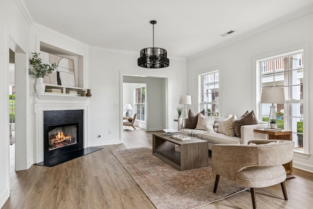 140 Ormesby Pl, Franklin, TN 37064 - living area featuring wood finished floors, crown molding, a lit fireplace, and a chandelier