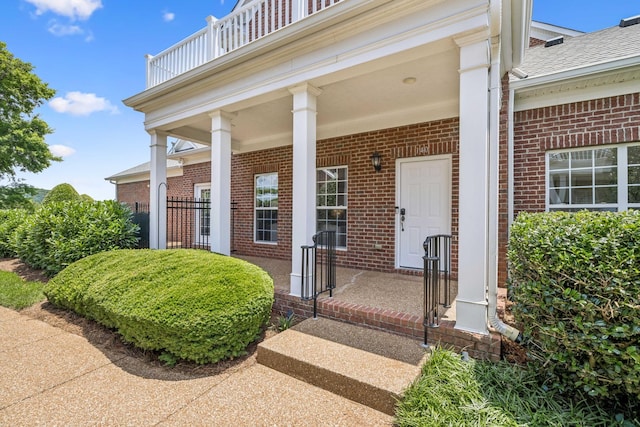 140 Ormesby Pl, Franklin, TN 37064 - doorway to property with brick siding, covered porch, a shingled roof, and a balcony