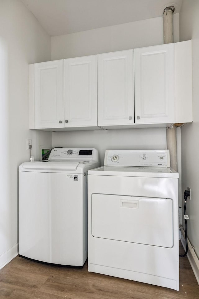 140 Ormesby Pl, Franklin, TN 37064 - laundry area with washer and dryer, cabinet space, and wood finished floors