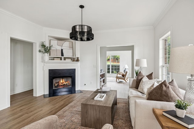 140 Ormesby Pl, Franklin, TN 37064 - living room featuring crown molding, wood finished floors, a lit fireplace, and a chandelier