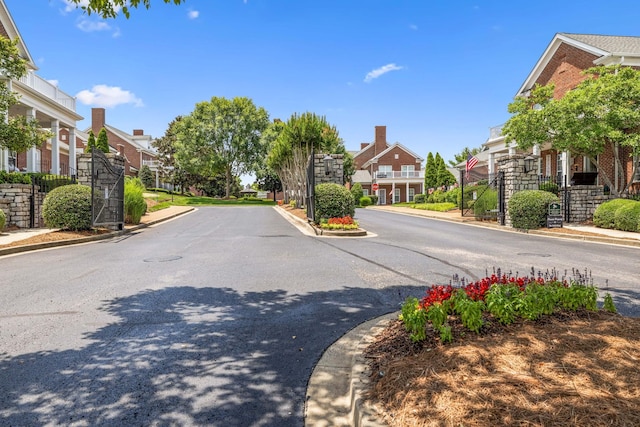 140 Ormesby Pl, Franklin, TN 37064 - view of asphalt road featuring a residential view, curbs, and a gated entry