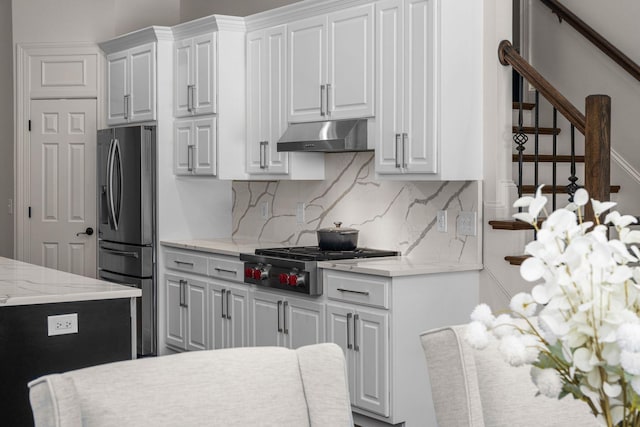 5605 Ottershaw Ct, Brentwood, TN 37027 - kitchen with appliances with stainless steel finishes, under cabinet range hood, backsplash, and white cabinetry
