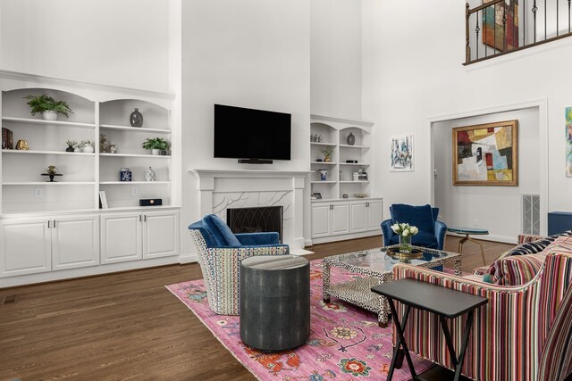 5605 Ottershaw Ct, Brentwood, TN 37027 - living room with dark wood-style floors, a towering ceiling, a premium fireplace, and built in features