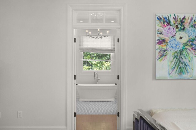 5605 Ottershaw Ct, Brentwood, TN 37027 - bathroom featuring a chandelier, a freestanding bath, vanity, and wood finished floors