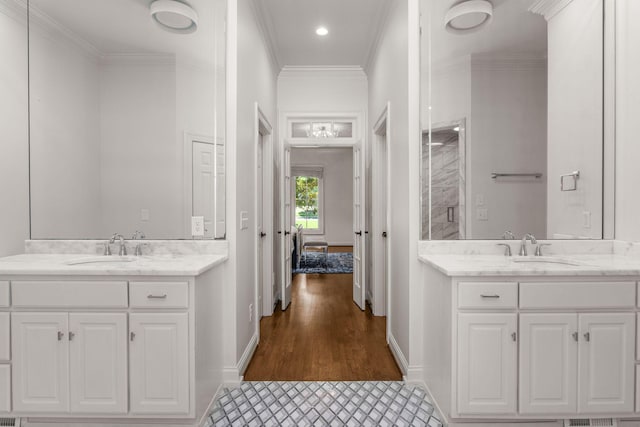 5605 Ottershaw Ct, Brentwood, TN 37027 - bathroom featuring two vanities, crown molding, recessed lighting, wood finished floors, and a shower