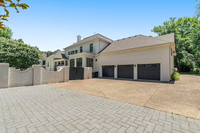5605 Ottershaw Ct, Brentwood, TN 37027 - view of front of home featuring a gate, concrete driveway, a garage, and brick siding