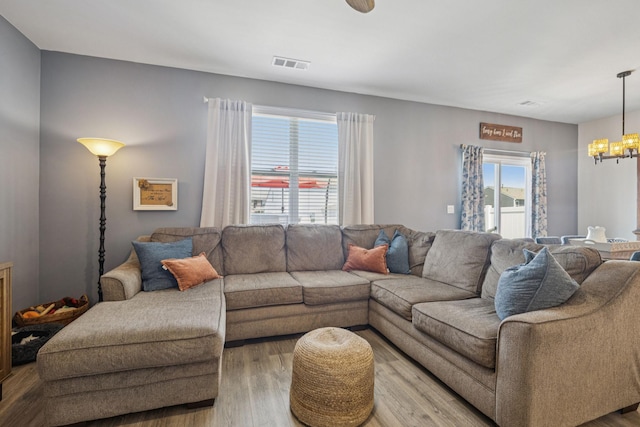 2410 Tate Farm Ln, White House, TN 37188 - living room featuring wood finished floors and a chandelier