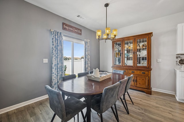 2410 Tate Farm Ln, White House, TN 37188 - dining area featuring a chandelier and light wood-type flooring