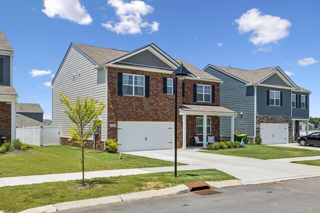 2410 Tate Farm Ln, White House, TN 37188 - view of front of home with driveway, an attached garage, and brick siding
