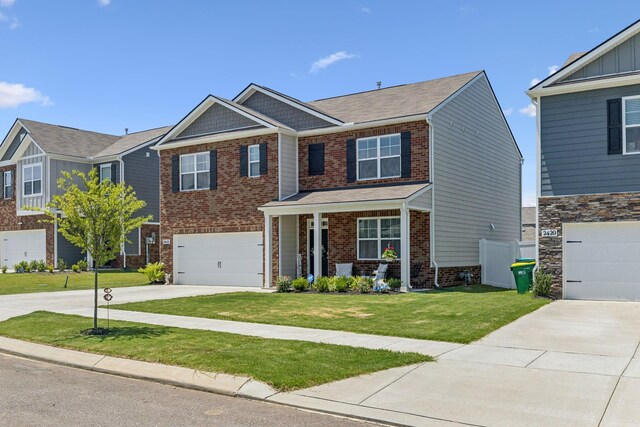 2410 Tate Farm Ln, White House, TN 37188 - craftsman-style home with driveway, a front lawn, a garage, and brick siding