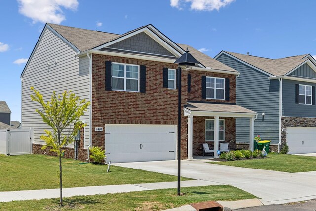 2410 Tate Farm Ln, White House, TN 37188 - view of front facade with a garage, driveway, and brick siding