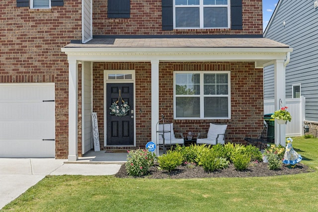 2410 Tate Farm Ln, White House, TN 37188 - view of exterior entry with a porch, brick siding, driveway, and a lawn