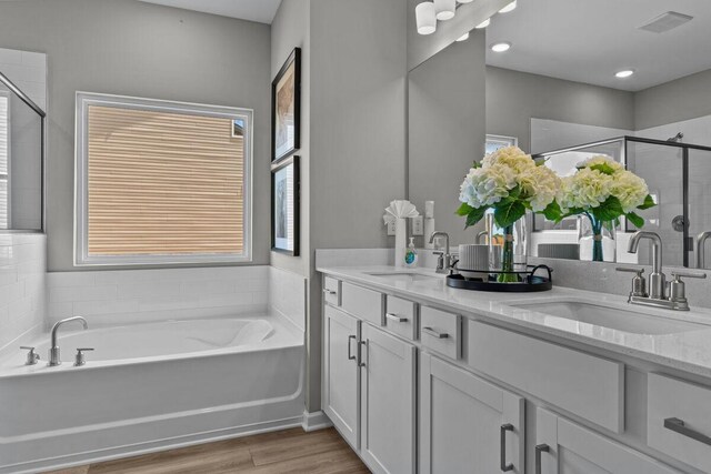 109 Model Ct, Columbia, TN 38401 - bathroom featuring double vanity, a bath, a shower stall, and wood finished floors