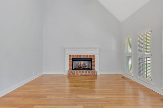 2910 Chaucer Dr, Murfreesboro, TN 37129 - unfurnished living room featuring light wood-type flooring, a brick fireplace, and high vaulted ceiling