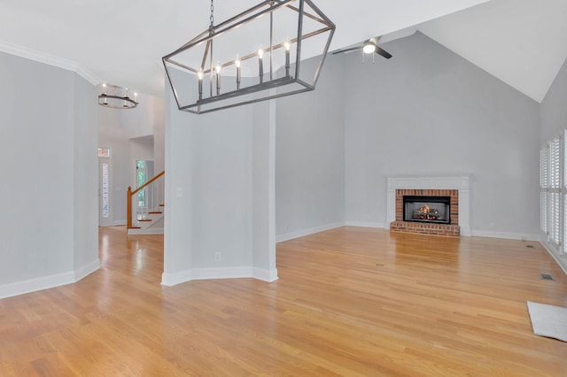 2910 Chaucer Dr, Murfreesboro, TN 37129 - unfurnished living room with light wood finished floors, stairway, a fireplace, high vaulted ceiling, and a ceiling fan