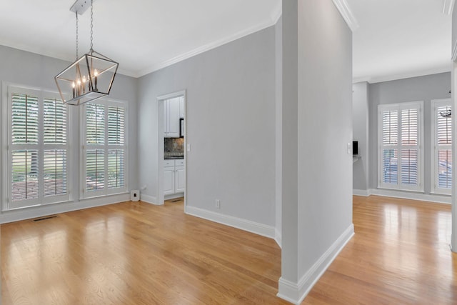 2910 Chaucer Dr, Murfreesboro, TN 37129 - unfurnished dining area with light wood-style flooring, a chandelier, and crown molding