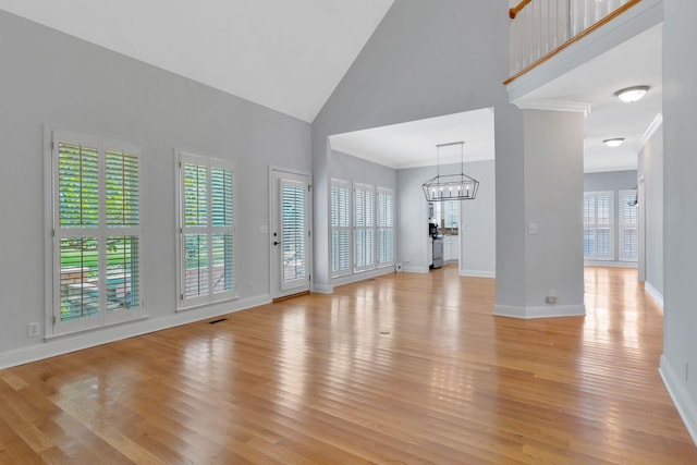 2910 Chaucer Dr, Murfreesboro, TN 37129 - unfurnished living room featuring a chandelier, high vaulted ceiling, and light wood-type flooring