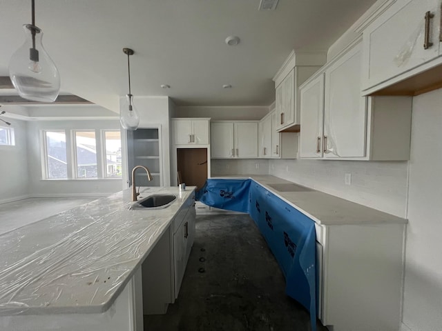 1830 Ableson Way, Columbia, TN 38401 - kitchen featuring white cabinetry, a center island with sink, tasteful backsplash, pendant lighting, and light countertops