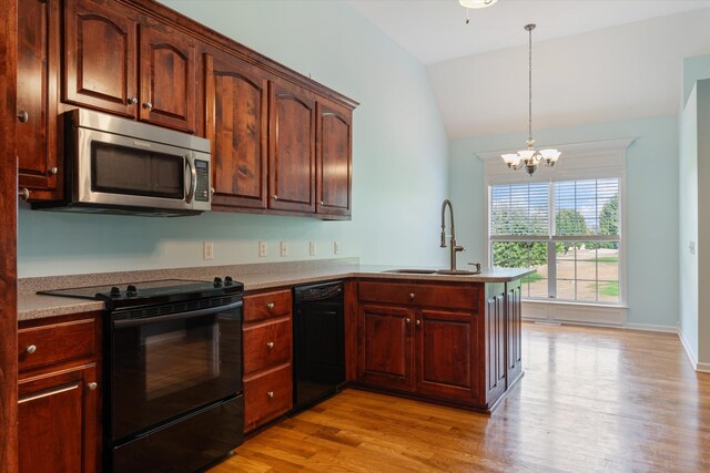 717 Pleasant View Dr, Columbia, TN 38401 - kitchen featuring black appliances, vaulted ceiling, light wood-type flooring, a peninsula, and a chandelier
