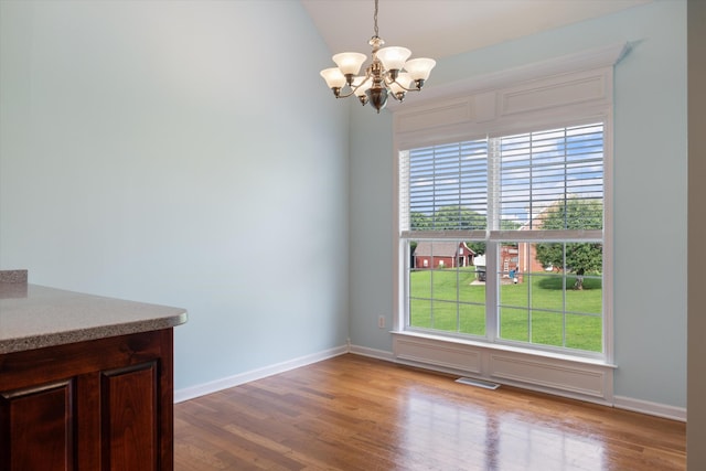 717 Pleasant View Dr, Columbia, TN 38401 - unfurnished dining area featuring a chandelier, wood finished floors, and vaulted ceiling