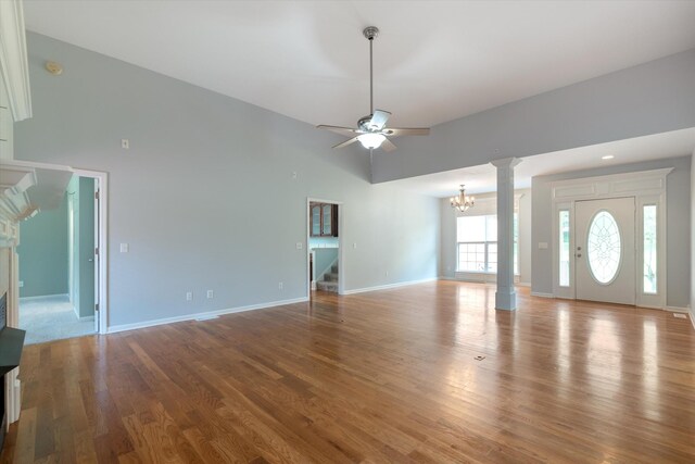 717 Pleasant View Dr, Columbia, TN 38401 - unfurnished living room featuring a chandelier, a ceiling fan, stairway, wood finished floors, and high vaulted ceiling